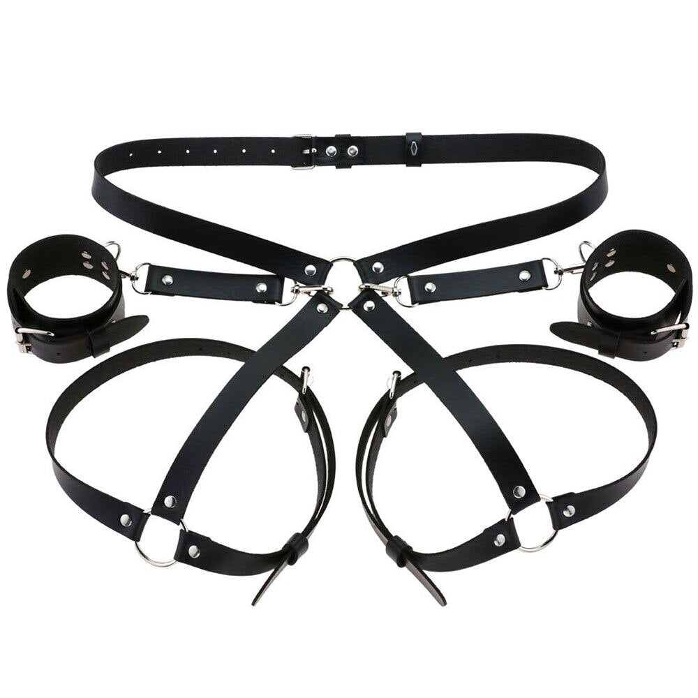 Flatlay of the Bae Cuff Booty Harness and matching cuffs in black vegan leather, highlighting adjustable straps and high-quality craftsmanship.