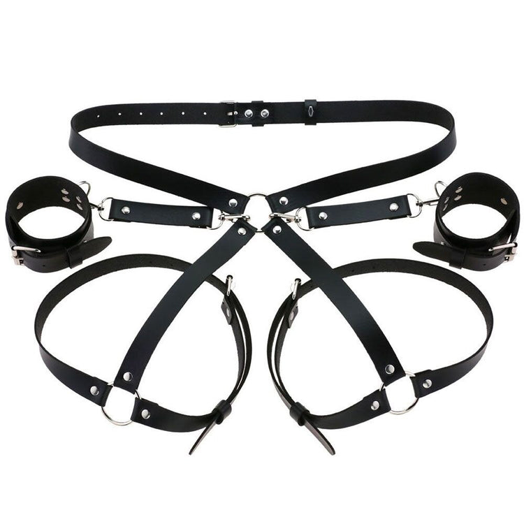Flatlay of the Bae Cuff Booty Harness and matching cuffs in black vegan leather, highlighting adjustable straps and high-quality craftsmanship.