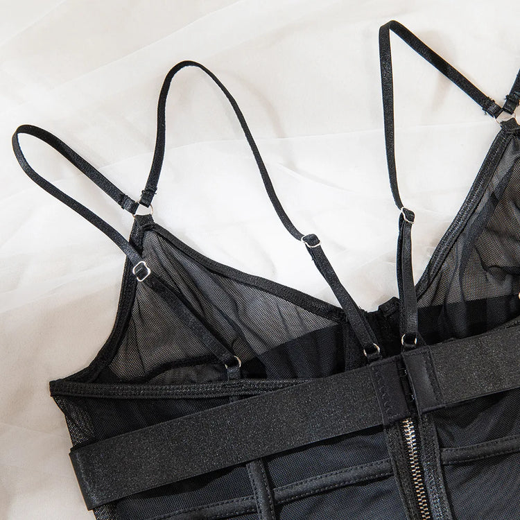 Flat lay of The Arabella lingerie bodysuit showing rear zip, mesh texture, and thong cut.