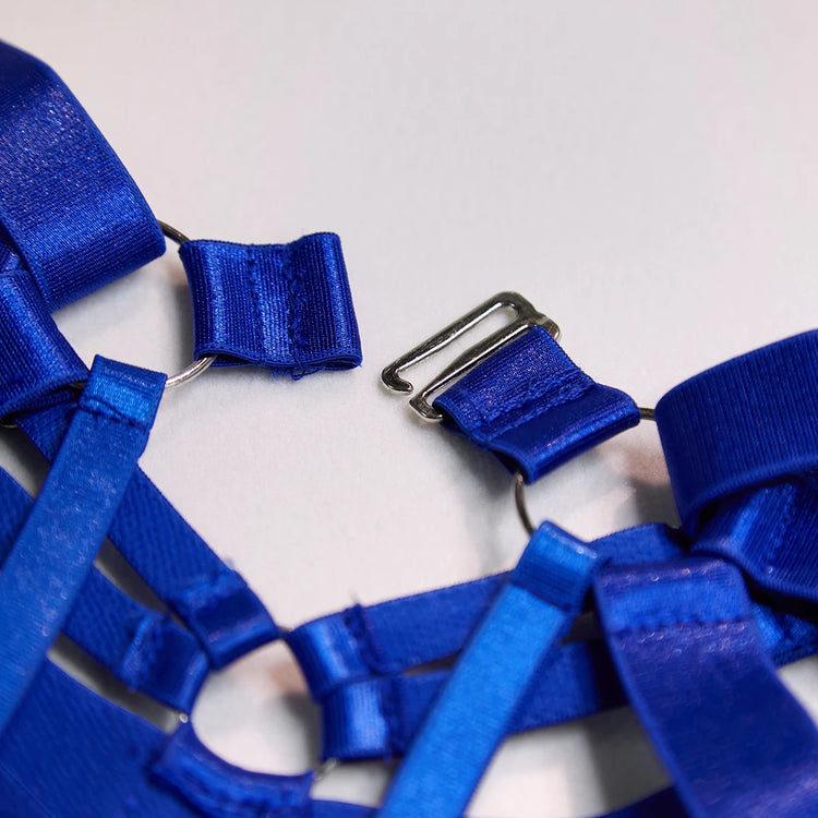 Close-up of The Harlow’s Clasp with silver-tone strappy lingerie hardware.