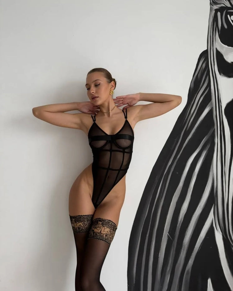 Model Posing in The Arabella lingerie bodysuit with sheer mesh cups and body-hugging seams.