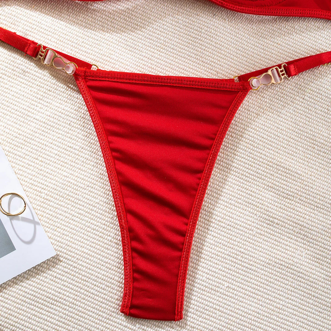 Close-up of gold hardware and red thong on The Ravena luxury lingerie set

