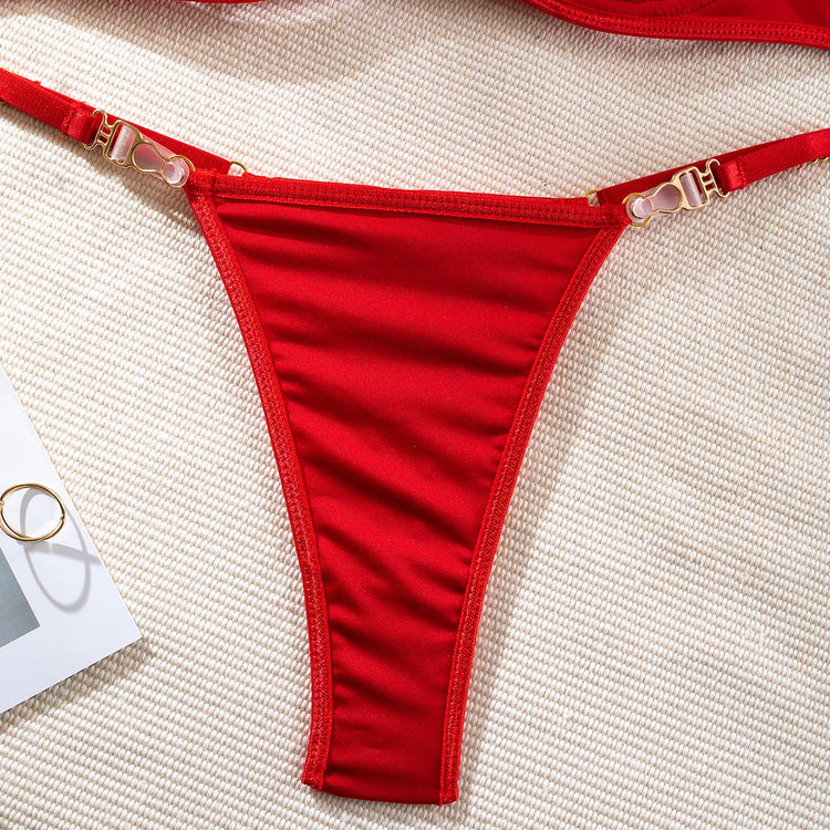 Close-up of gold hardware and red thong on The Ravena luxury lingerie set

